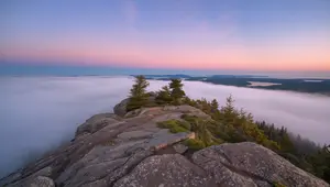 Sunrise view from Cadillac Mountain Trail overlooking Frenchman Bay and Bar Harbor under morning fog