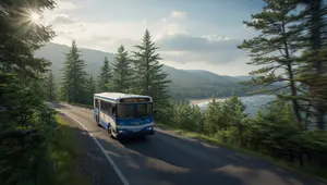 Island Explorer Shuttle driving along Park Loop Road in Acadia National Park with views of forested hills and the Atlantic Ocean.